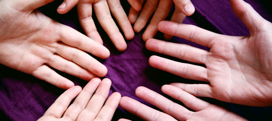 persons left hand on purple textile